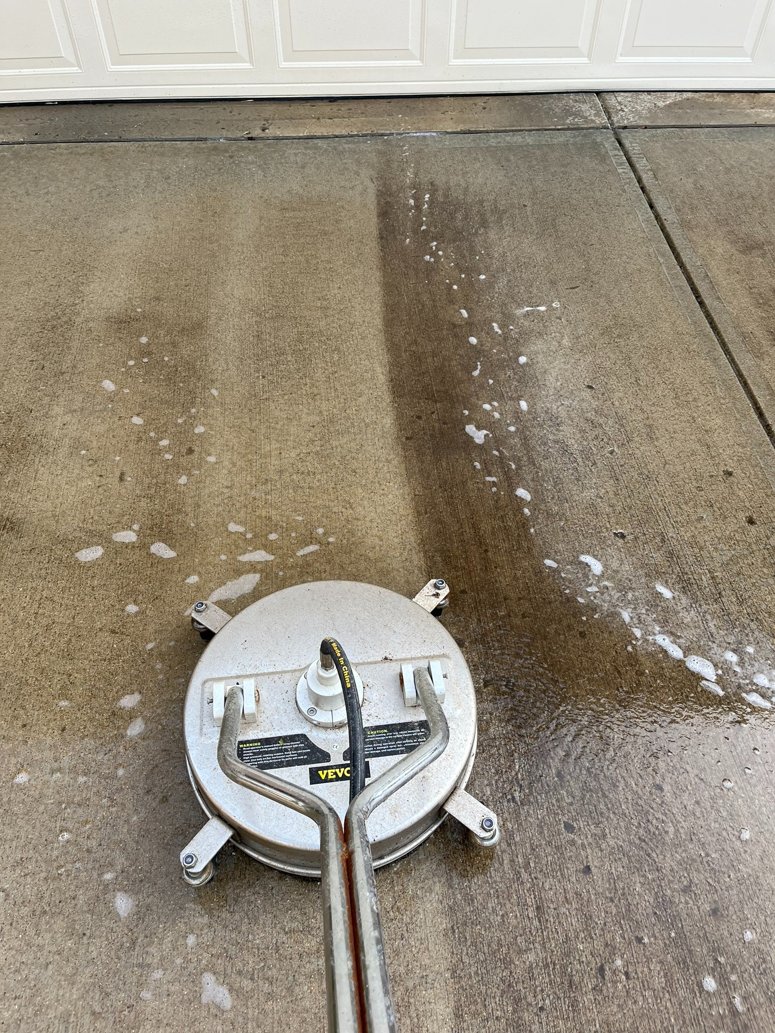 Professional driveway pressure washing in action